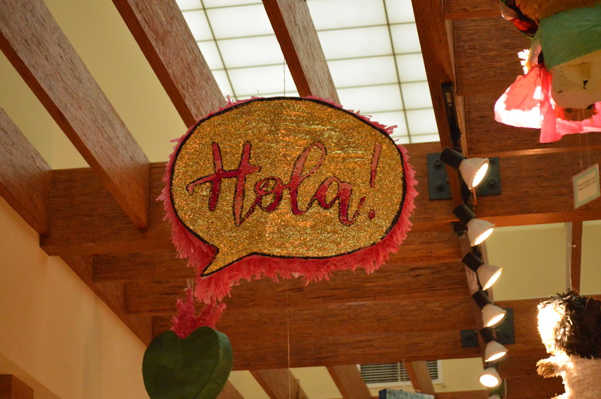 One of the piñatas on display in Smoky Hill Library on Sept. 14 is of a sign that says, "Hola!"